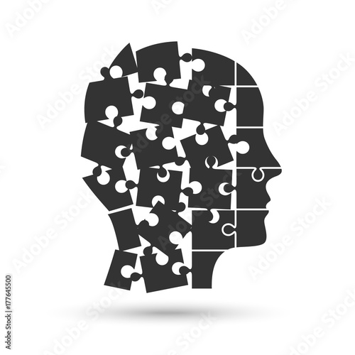 Head profile silhouette made of jigsaw puzzle pieces falling apart