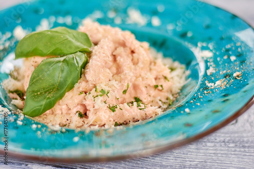 Delicious italian pasta with fresh basil. Pasta creama di polo on plate. Delicious restaurant dish close up. photo