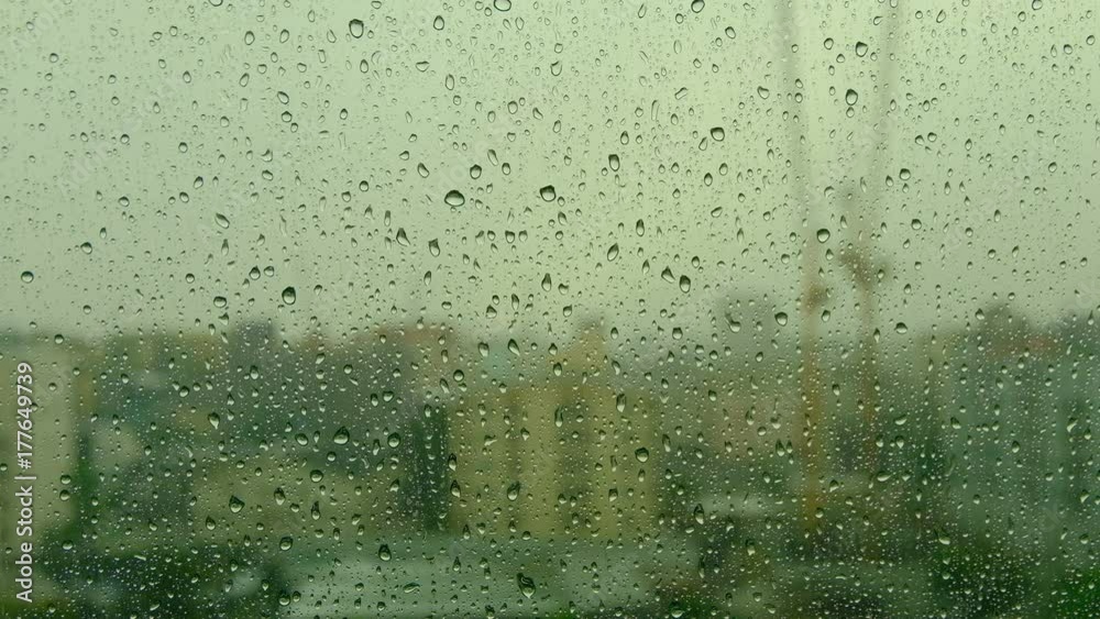 close up Drops of rain on the window on the background of the building close up Drops of rain on the window on the background of the building