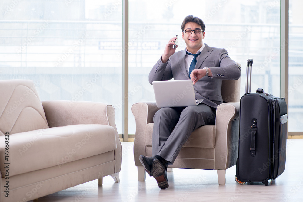 Fototapeta premium Young businessman in airport business lounge waiting for flight