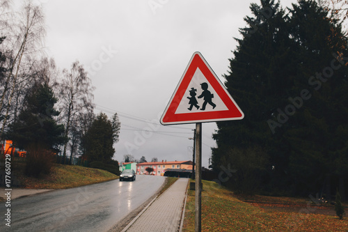 Triangle street sign with kids small european town