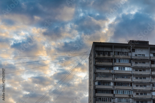 residential building and the beautiful sky with clouds. The problem of overcrowded and old housing