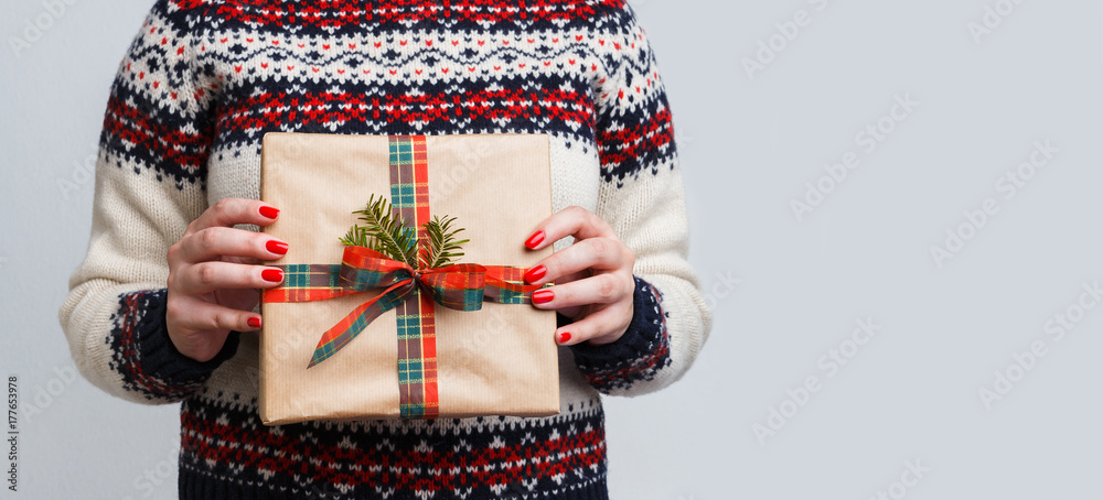 Unrecognizable woman holding christmas gift
