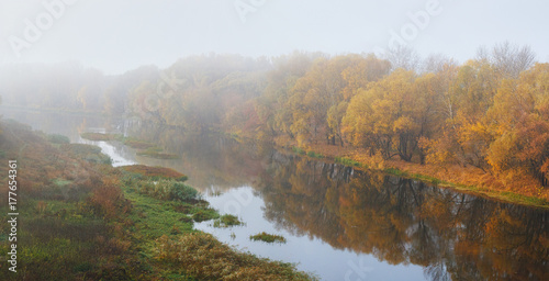 Autumn landscape with foggy mood weather on the river