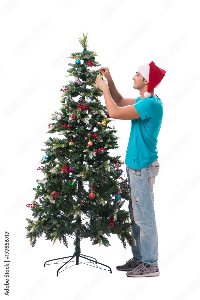 Young man decorating christmas tree isolated on white Young man decorating christmas tree isolated on white