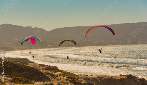 Paragliding over the beach and sea in Monterey Ca.