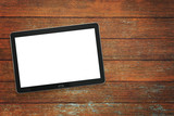 Mockup of a modern black silver digital tablet on a vintage wooden table ( high angel view)