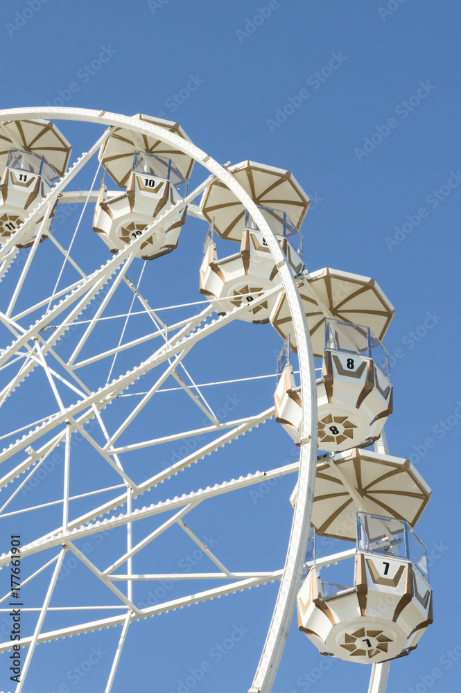 Panoramic ferris wheel with blue sky on background