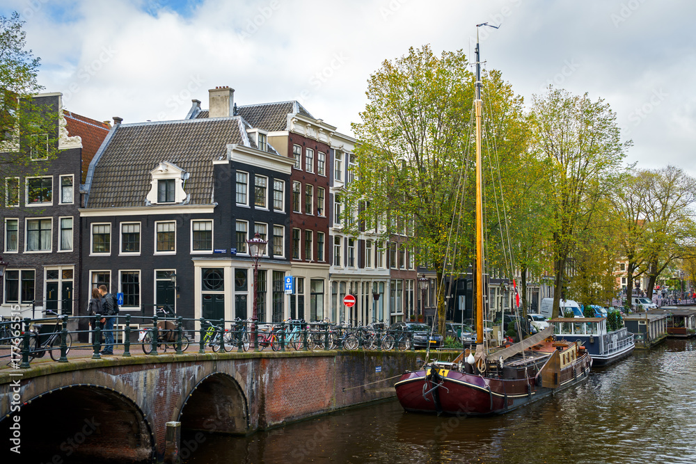 Traditional old houses and boats on Amsterdam canal, Netherlands, October 13, 2017