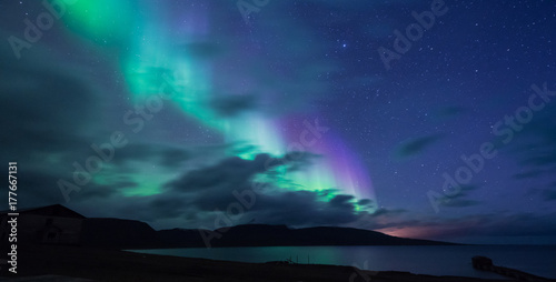 The polar arctic Northern lights aurora borealis sky star in Norway Svalbard in Longyearbyen the moon mountains © bublik_polina