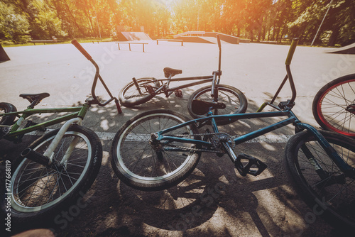 Bmx bicycles lays on the ground in the skatepark. Bicycle repair
