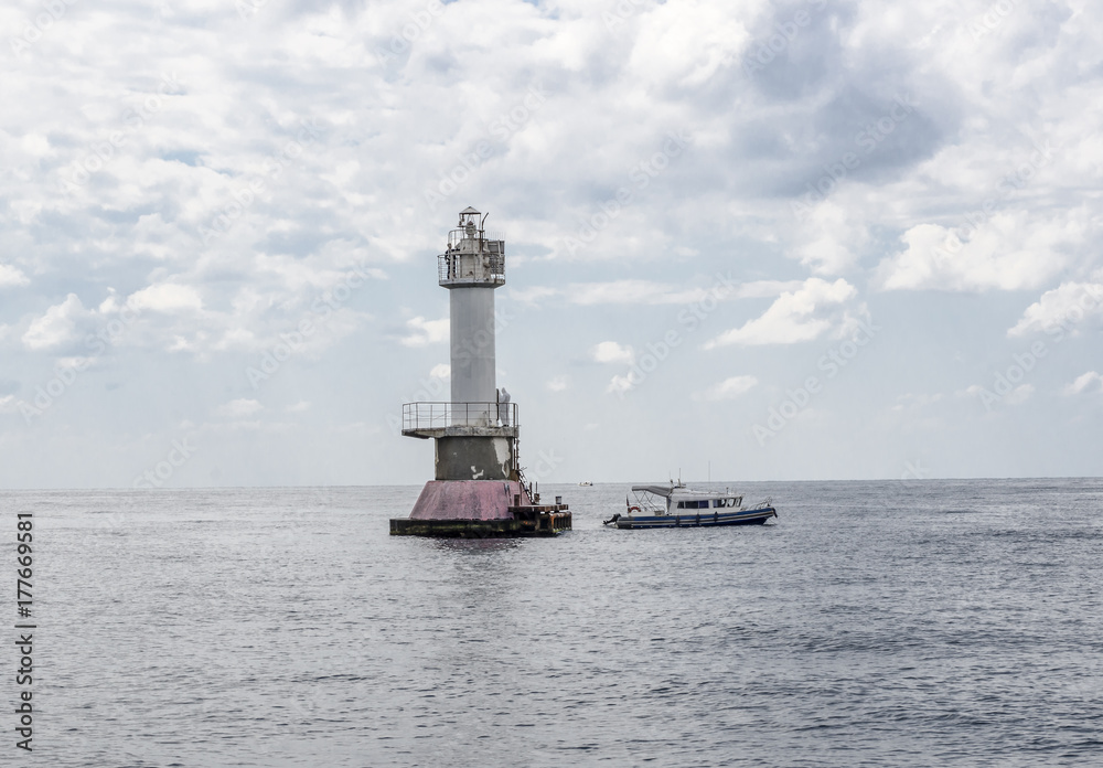 Tower of the lighthouse in the open sea.