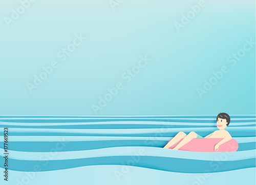 Fotografie Man floating on the beach with beautiful sea