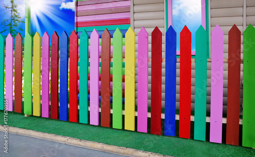 The fence is painted with paints of different colors