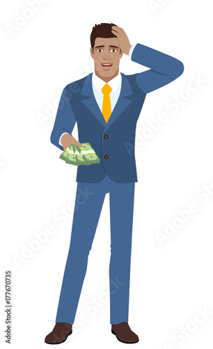 Businessman with money grabbed his head