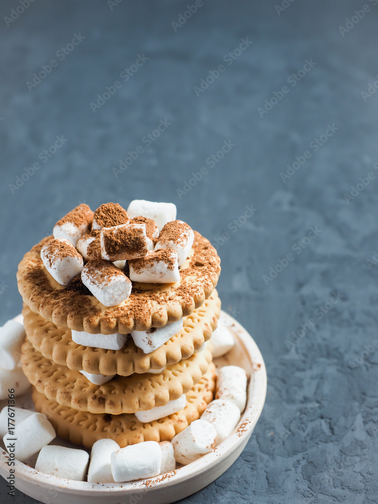Marshmallow brownies with chocolate on the cookies in layers on textured grey concrete background. Copy space. Marshmallow brownies with chocolate on the cookies in layers on textured grey concrete background. Copy space.