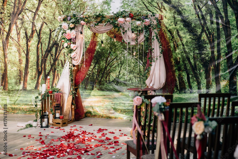 Wedding ceremony arch, altar decorated with flowers on the lawn