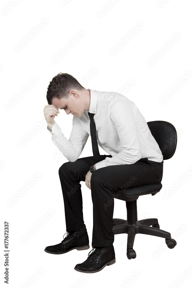 Stressed businessman with a chair on studio Stressed businessman with a chair on studio