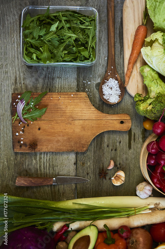 Fresh raw vegetables with cutting board on wooden background copy space for text. Design moce up photo