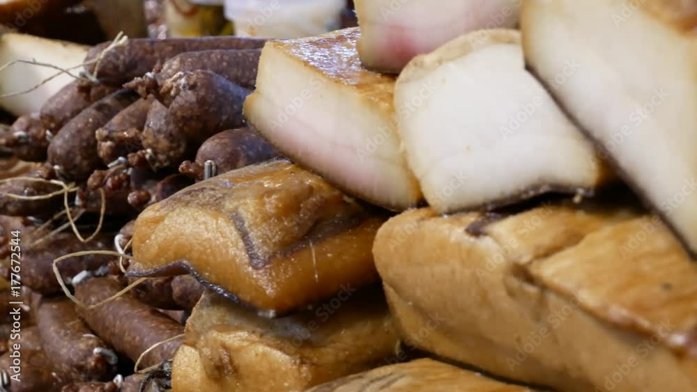Different kinds of smoked sausages, salami and bacon for sale. Different kinds of smoked sausages, salami and bacon for sale.