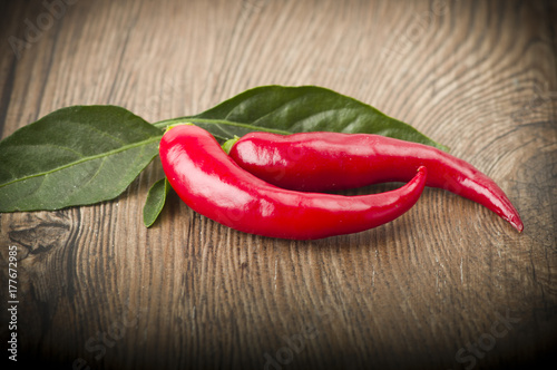 Red chili pepper isolated on a wood background