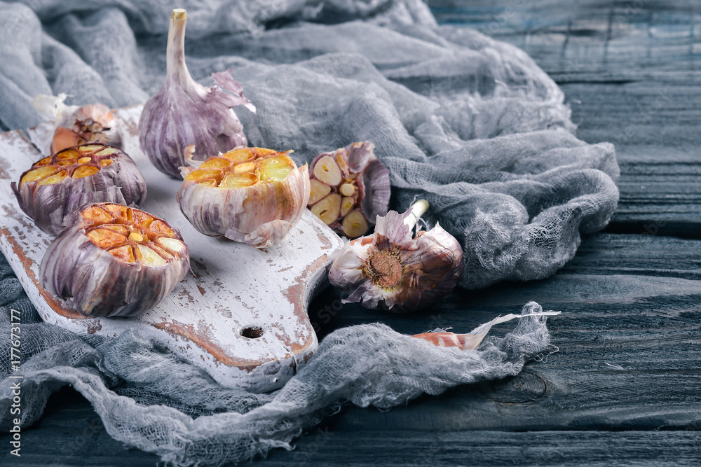 Garlic. On a wooden background. Top view. Free space for your text.