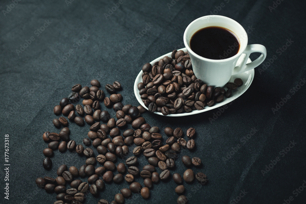 Cup of coffee with beans on a black background. Cup of coffee with beans on a black background.