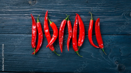 Chili red pepper. On a wooden background. Top view. Free space for your text.
