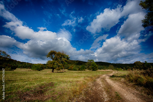 rocky road running through the boulders and a wonderful blue sky with white clouds