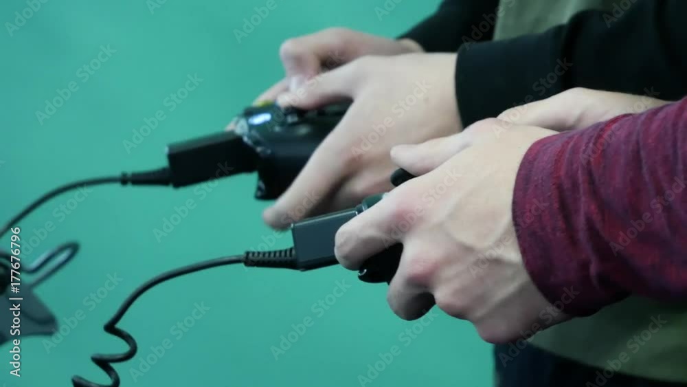 Two men playing video games on their gaming console. Two men playing video games on their gaming console.