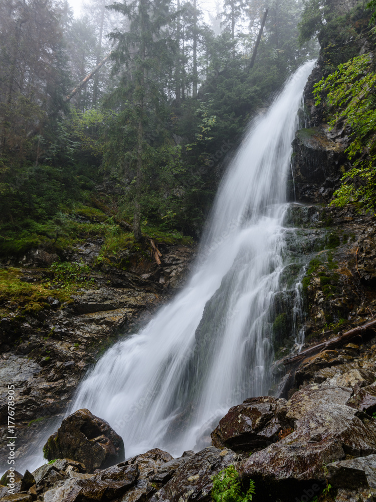 Fototapeta premium large Waterfall from ravine in autumn, long exposure