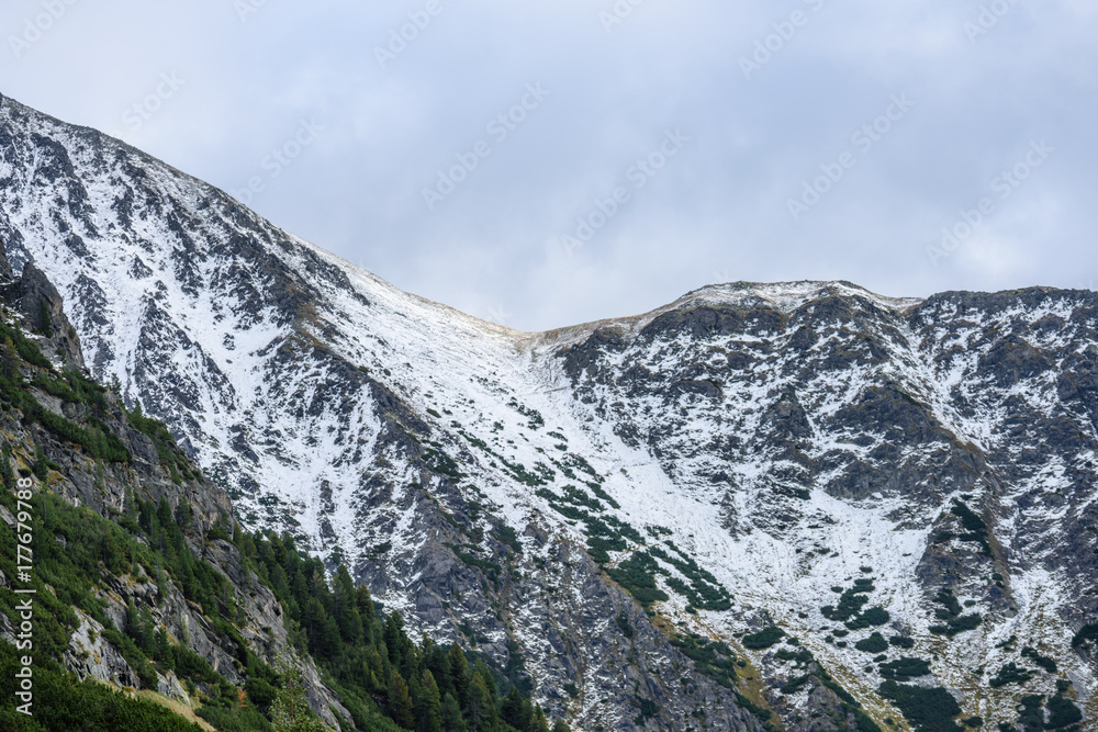 panoramic view of Tatra mountains in Slovakia covered with snow and hiding in mist