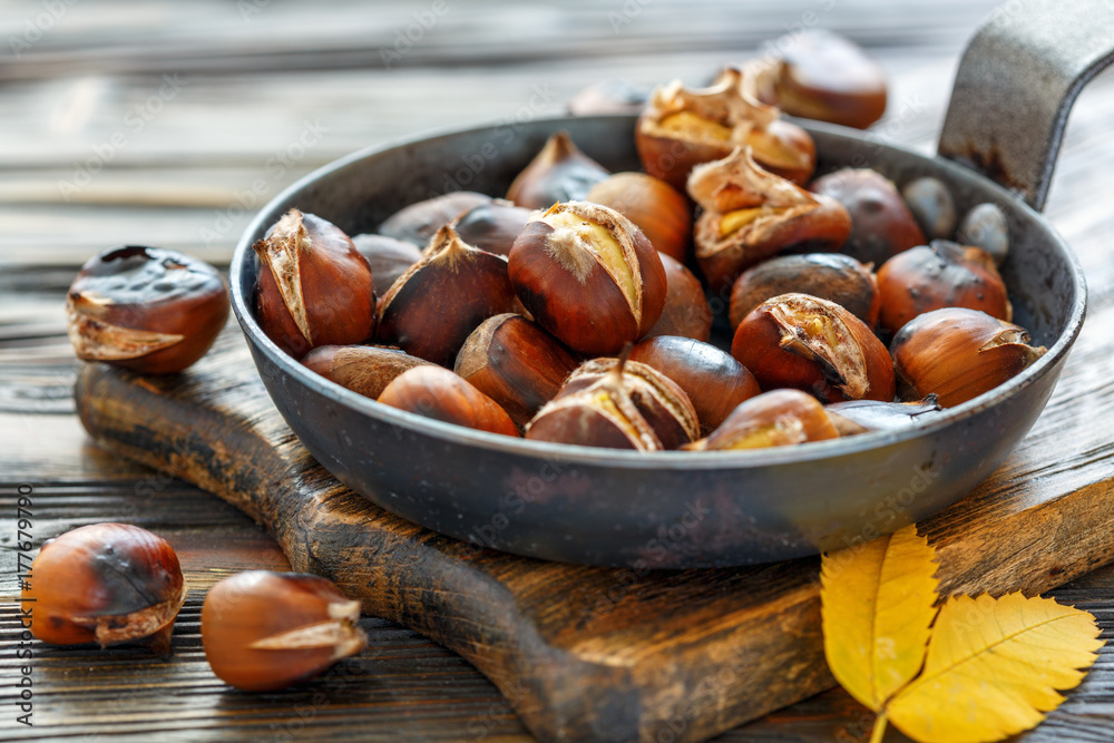 Roast chestnuts in a pan closeup. Roast chestnuts in a pan closeup.