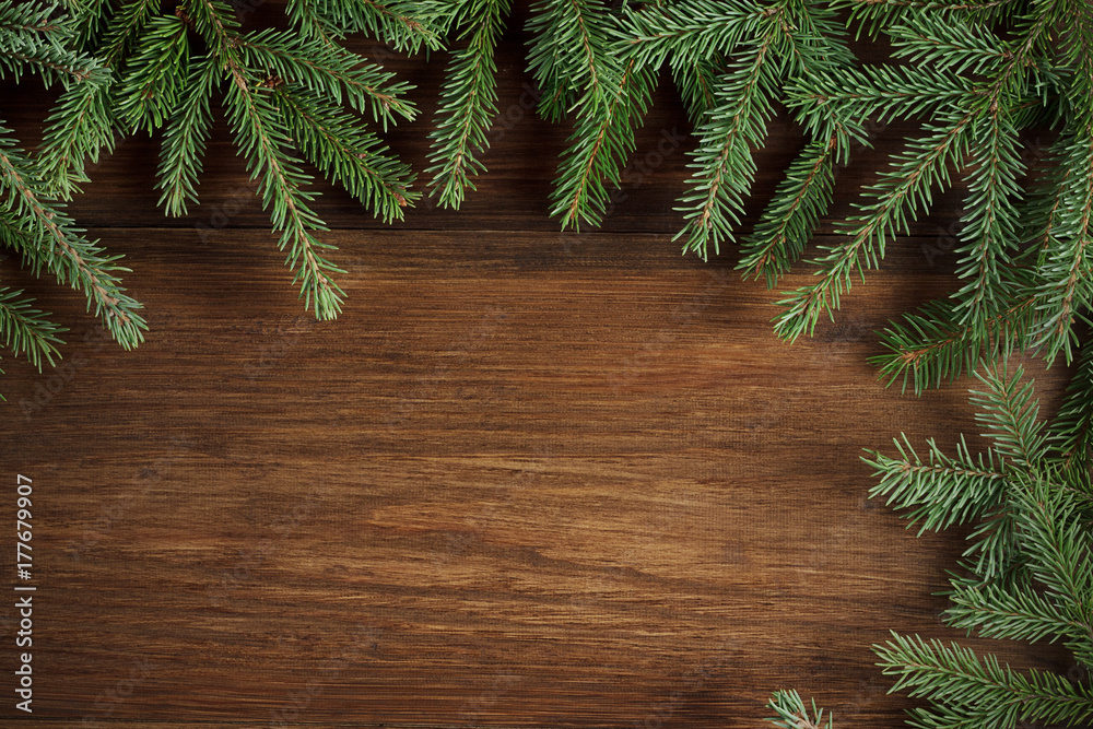Christmas rustic wooden backdrop with evergreen branches.