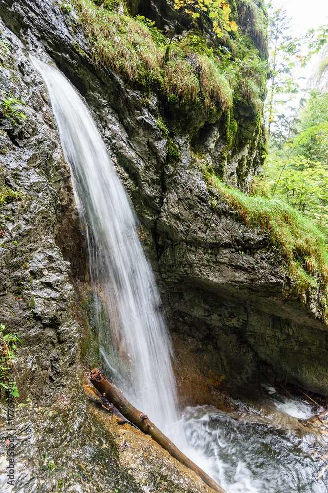 Naklejka premium large Waterfall from ravine in autumn, long exposure