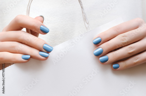Beautiful female hands with blue manicure