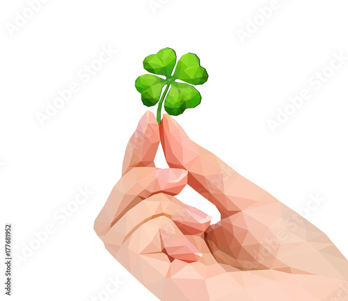polygonal hand studio photo keeps clover in the fingers