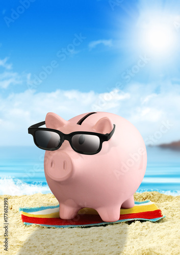 Piggy bank on the beach, money for travel concept