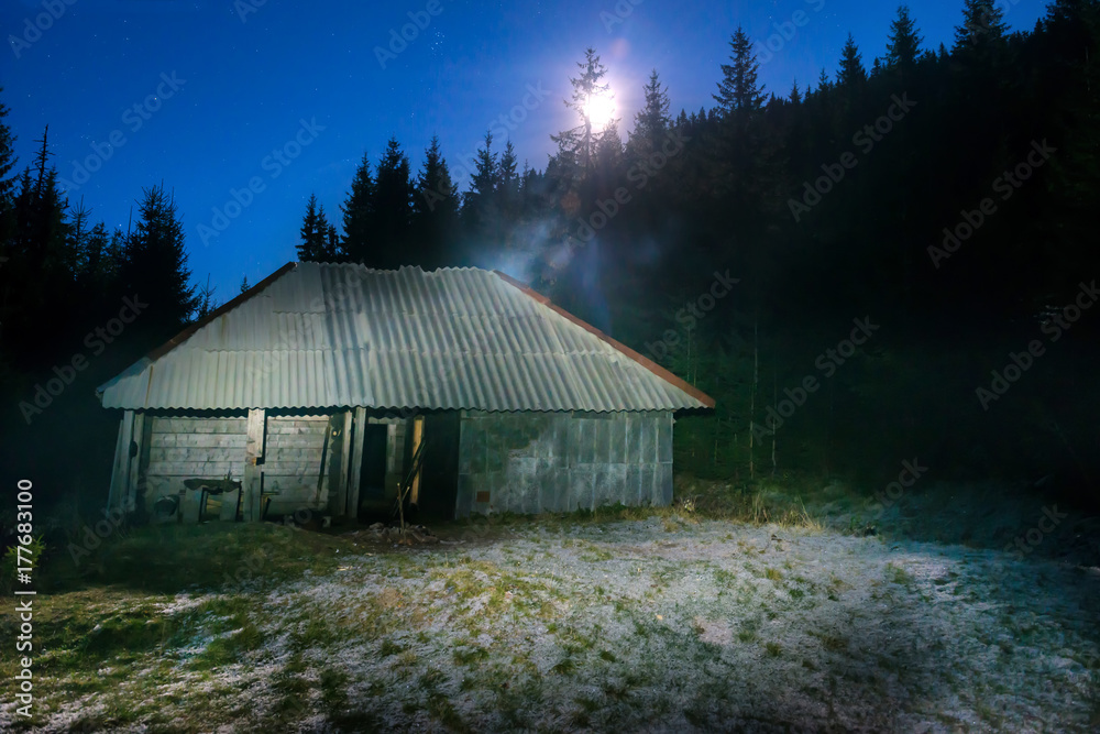 Old house in forest at night