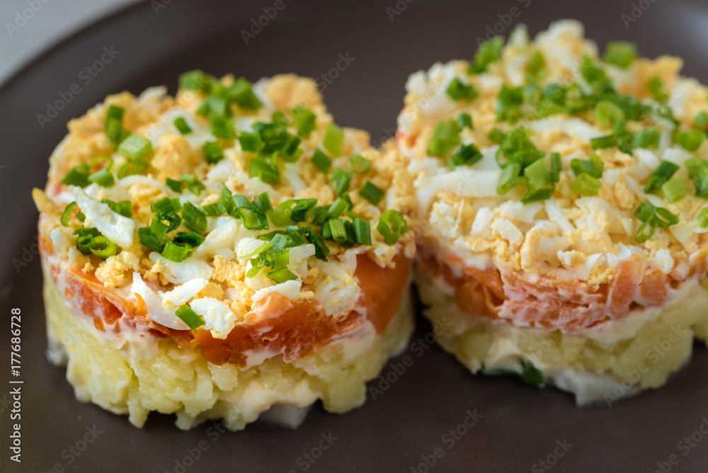 Herring under the coat - multilayer salad from herring, potatoes, carrots and eggs decorated with chives. Herring under the coat - multilayer salad from herring, potatoes, carrots and eggs decorated with chives.