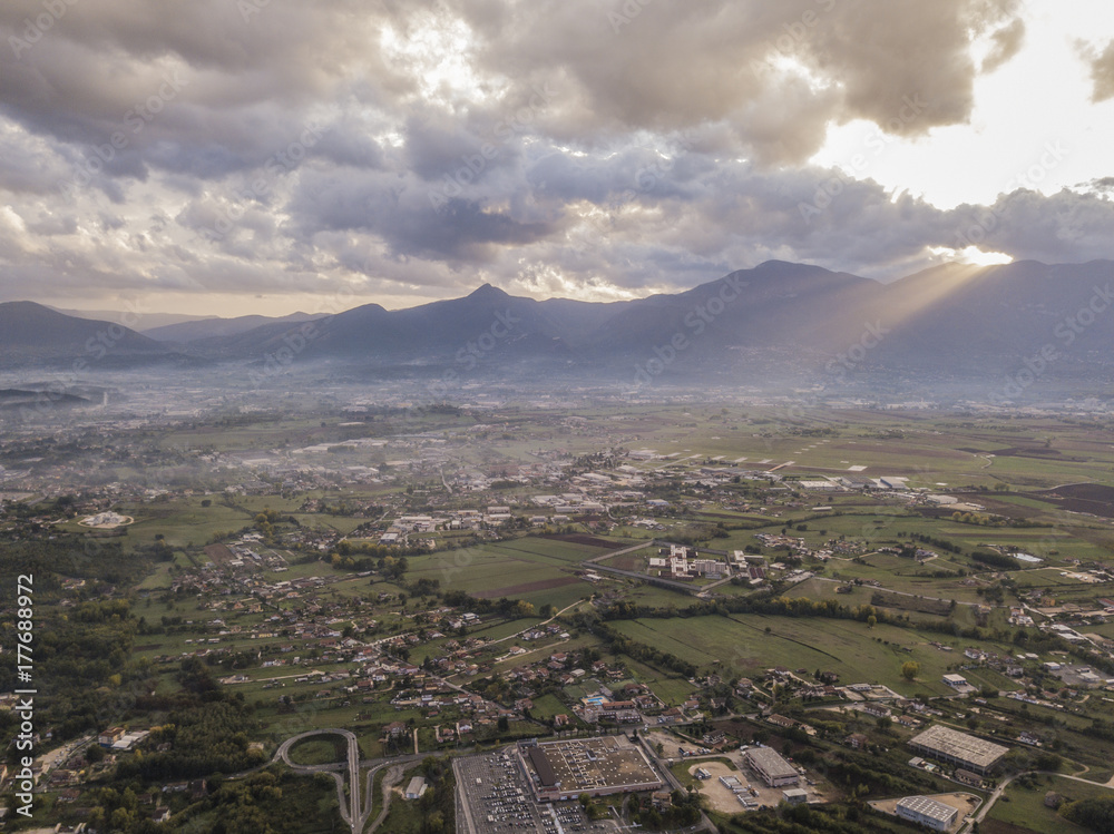 Aerial view of a cloudy day in an Italian countryside at sunset