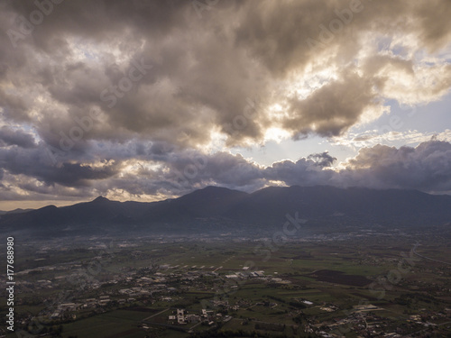 Aerial view of a cloudy day in an Italian countryside at sunset photo