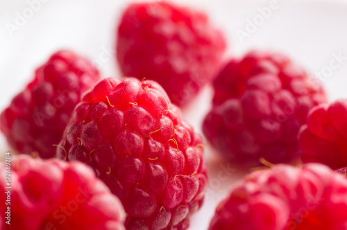 raspberries on a white saucer close up