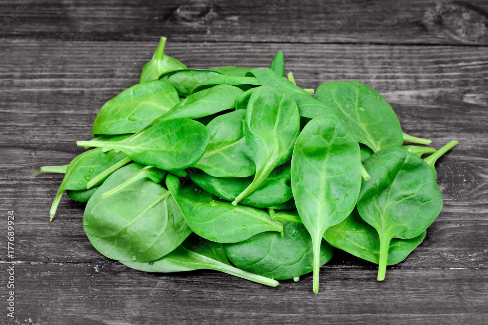 Heap of fresh green baby spinach on table Heap of fresh green baby spinach on table