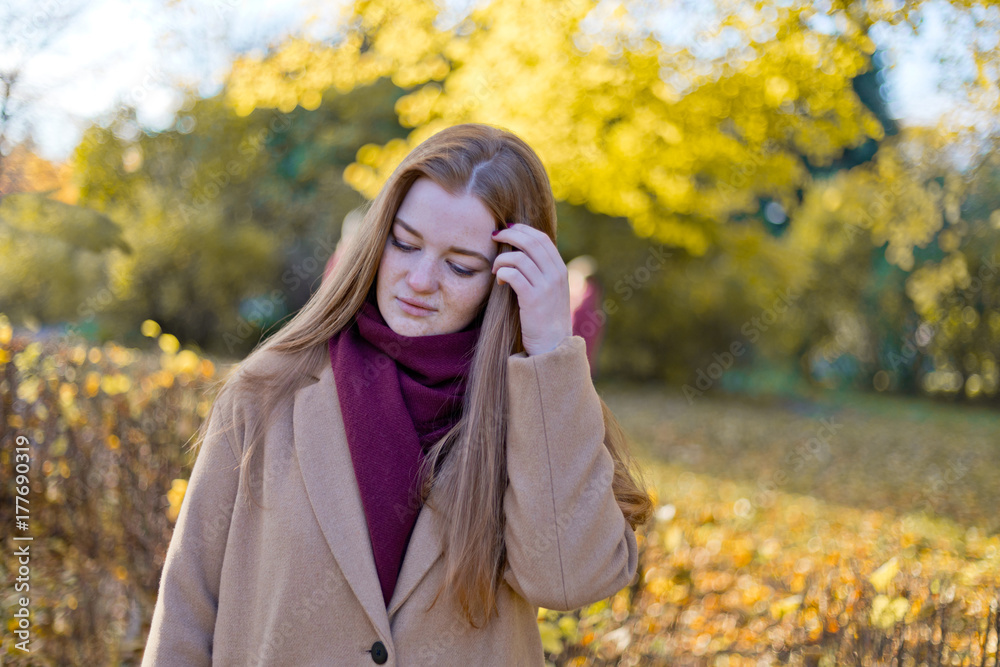 Girl doubting, thoughtful in the autumn park Girl doubting, thoughtful in the autumn park