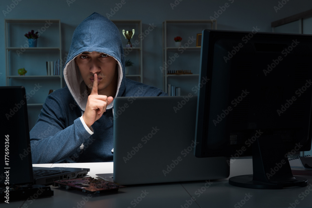 Hacker hacking computer at night