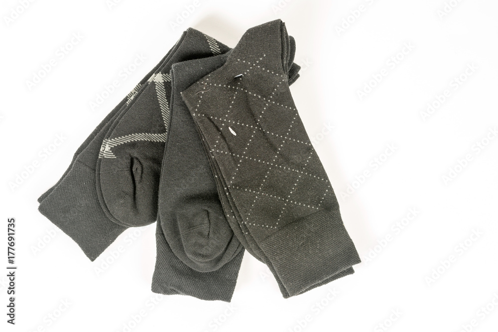 Fototapeta premium Pile of mens black socks isolated on white background