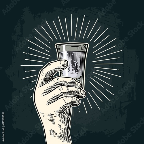 Male hand holding glass rum.  Vintage vector engraving