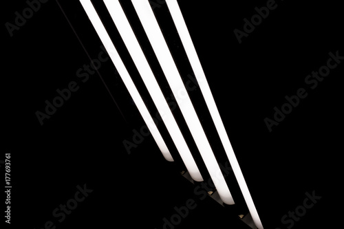 LED fluorescent light tubes on black background. Professional lighting equipment for photo or video production.