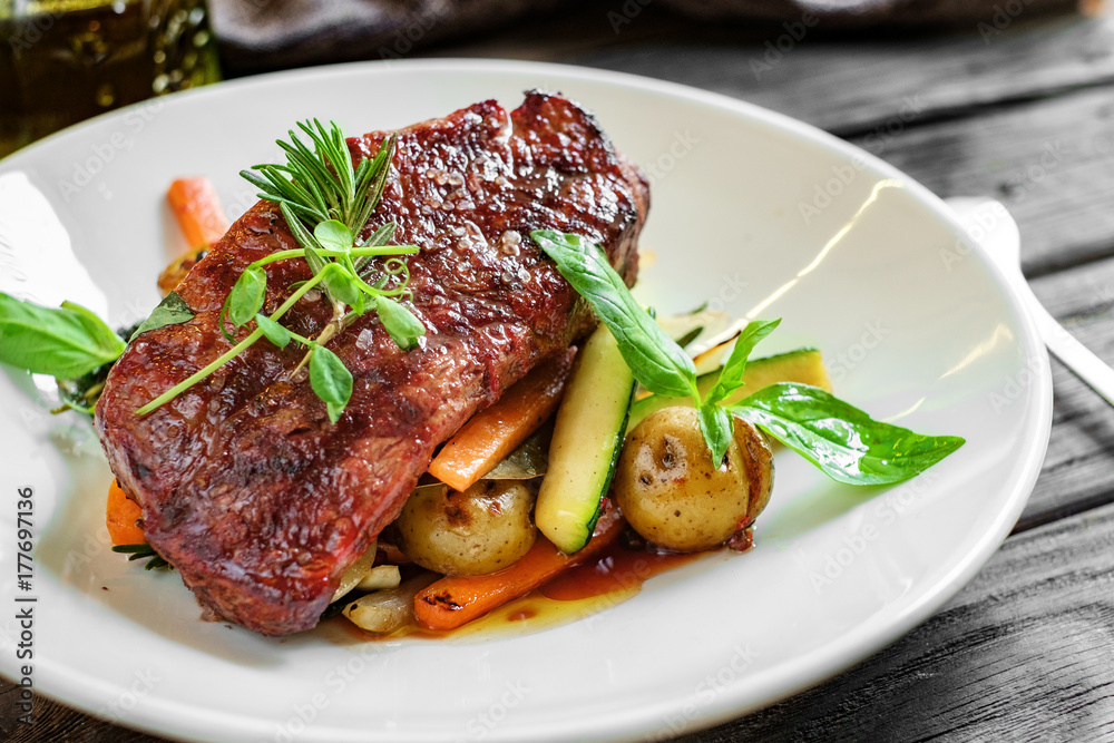 grilled beef steak with vegetables on plate